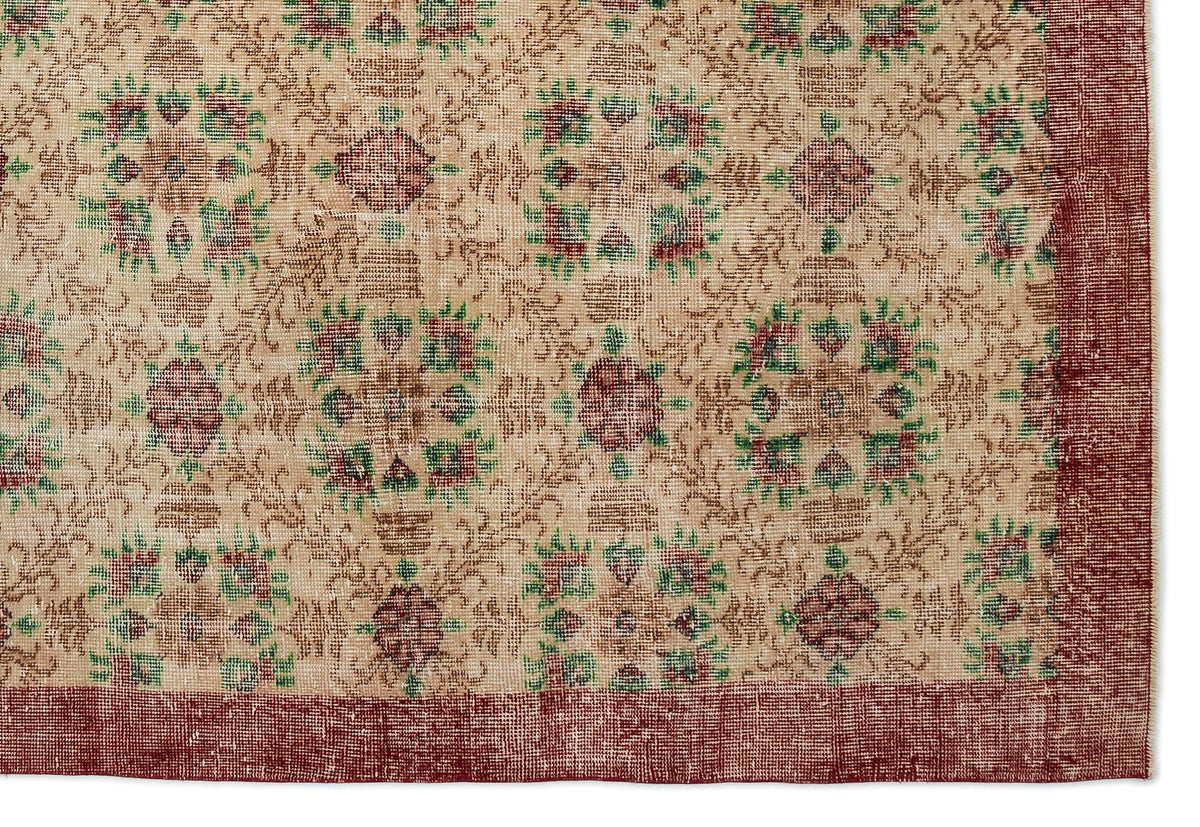 Beige rug with a repeating floral medallion pattern in red and green, featuring a solid dark red border.