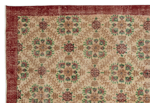 Load image 1 in gallery view. Beige rug with a red border and repeating floral medallion pattern in red and green on a white background.