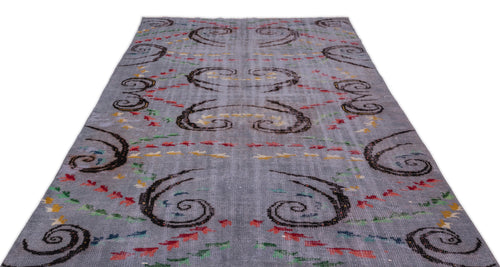 Load image 1 in gallery view. Grey rug with dark brown spiral motifs and scattered red, yellow, and green dash accents on a white background.