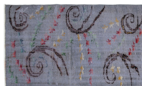 Load image 1 in gallery view. Grey rug with dark brown spiral motifs and scattered red, yellow, and green abstract accents.