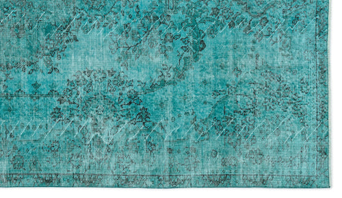 Load image 1 in gallery view. Teal rug with a distressed, faded floral medallion pattern and a visible woven texture.