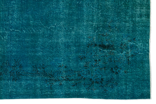 Load image 1 in gallery view. Teal distressed rug with a faded black floral pattern and visible horizontal weave texture.