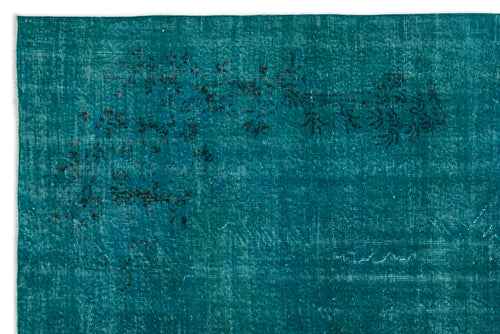 Load image 1 in gallery view. Teal rug with a distressed, faded floral pattern in black, featuring a visible woven texture.