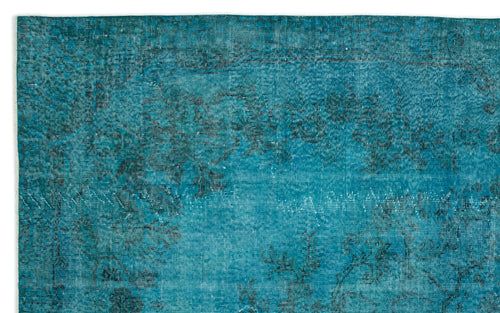Load image 1 in gallery view. Teal distressed rug with a faded black traditional floral pattern.