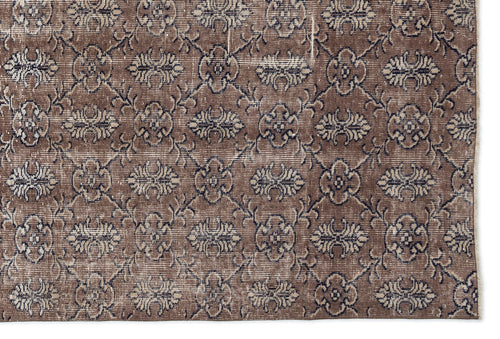 Load image 1 in gallery view. Brown and charcoal grey vintage-style rug with a repeating floral medallion pattern on a white background.