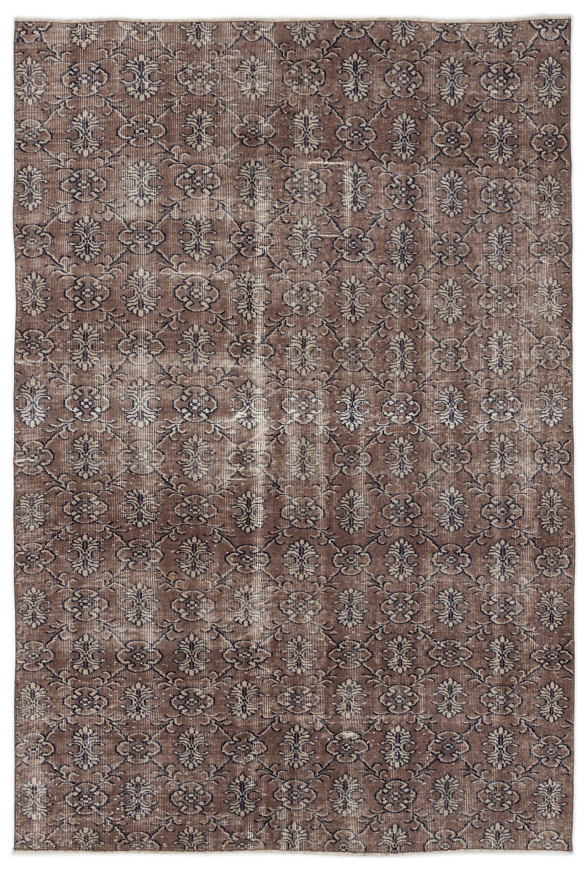 Brown and dark blue distressed rug with an all-over repeating floral medallion pattern.