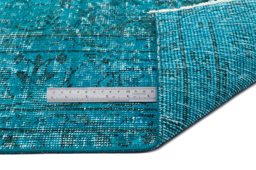 Load image 1 in gallery view. Teal and black distressed medallion rug with a folded corner and a stainless steel ruler for scale.
