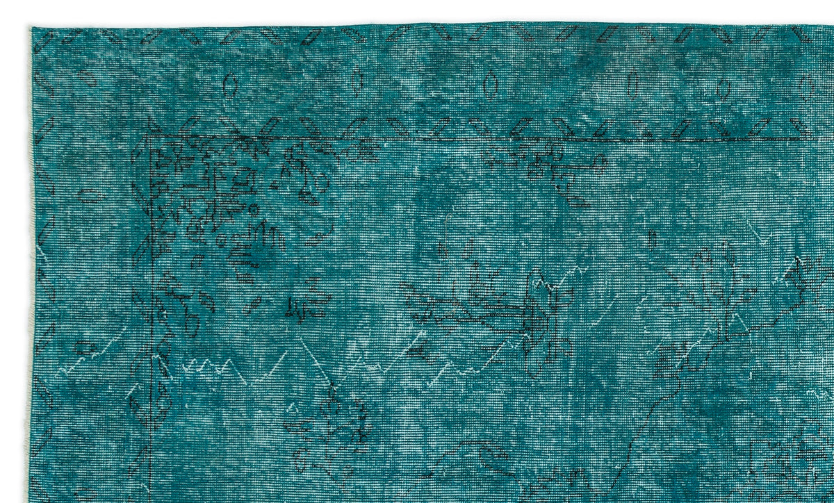 Teal distressed rug with a faded black traditional floral border and central medallion pattern.