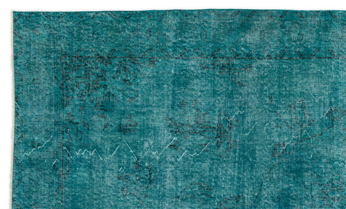 Load image 1 in gallery view. Teal distressed rug with a faded black traditional floral border and central medallion pattern.