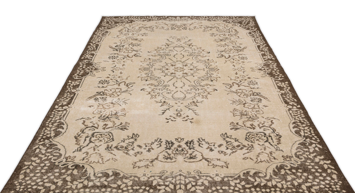 The Tiduex Vintage Medallion Rug (6'3" x 9'11") features a beige and brown rectangular design with intricate floral and ornamental patterns, a decorative border, and a central medallion.