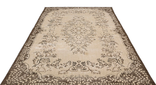 Load image 1 in gallery view. The Tiduex Vintage Medallion Rug (6'3" x 9'11") features a beige and brown rectangular design with intricate floral and ornamental patterns, a decorative border, and a central medallion.