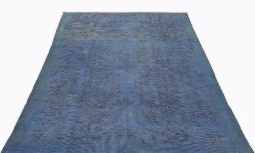 Load image 1 in gallery view. Deep blue vintage-style rug with a faint, distressed floral pattern on a white background.