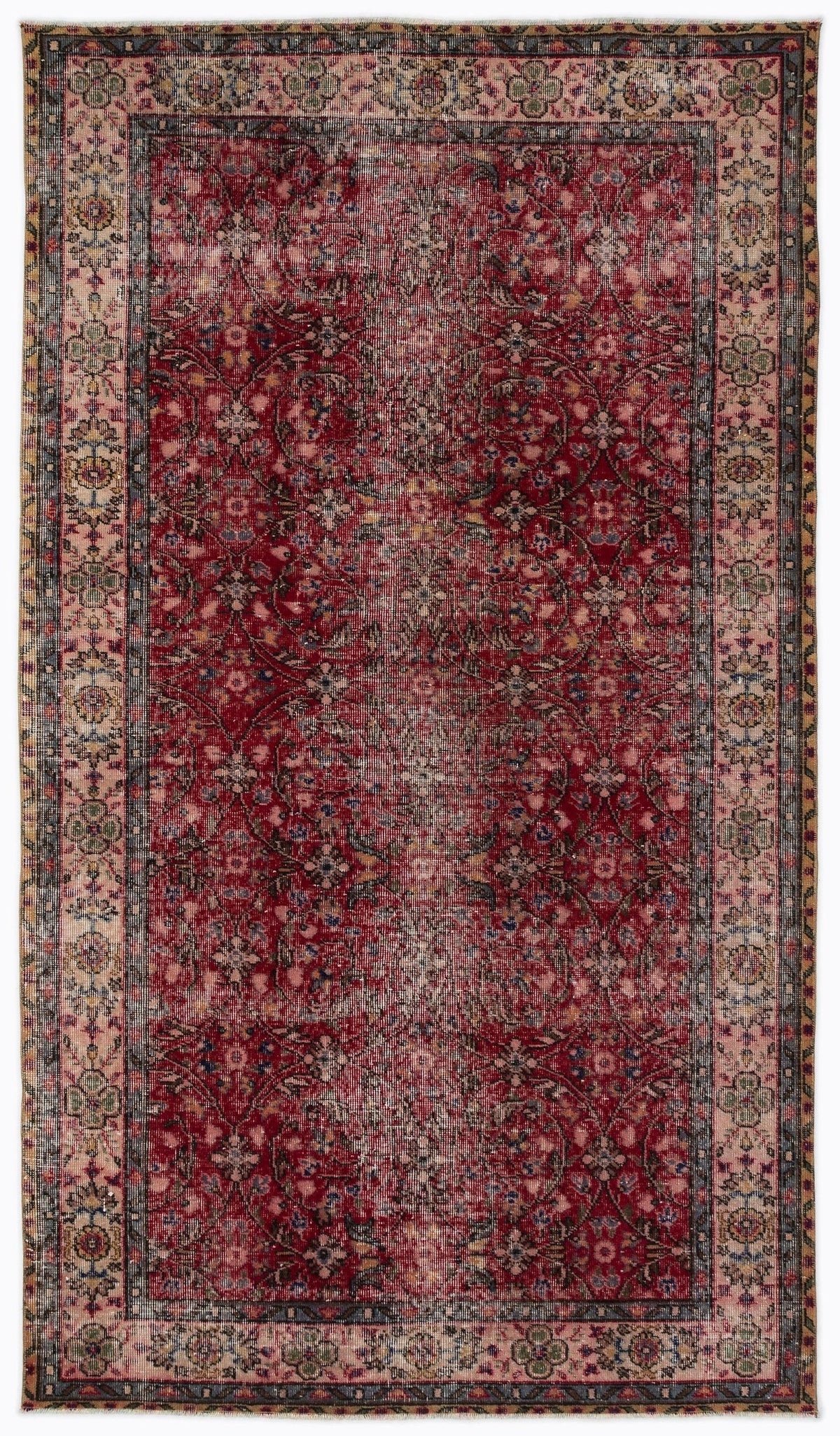 Distressed red Persian-style rug with a floral vine pattern and a wide, multi-colored decorative border.
