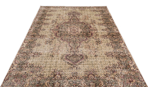 Load image 1 in gallery view. Distressed beige, olive green, and plum traditional rug with a central floral medallion and ornate border.