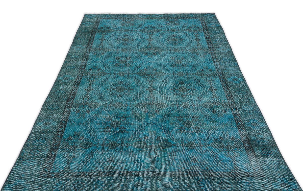 Teal and black distressed traditional rug with a central medallion pattern on a white background.