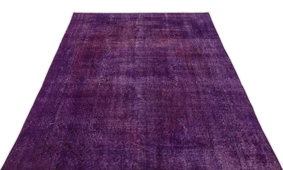 Deep purple vintage-style rug with a distressed, faded traditional pattern on a white background.