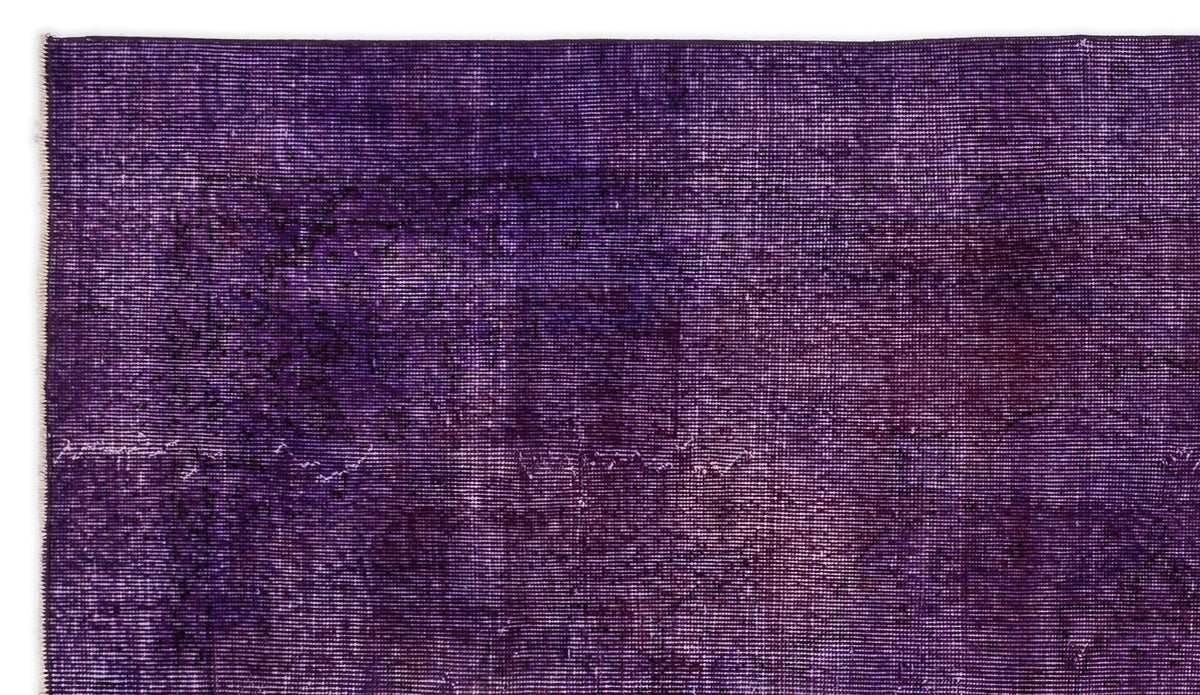Deep purple vintage-style rug with a distressed, faded traditional medallion pattern.