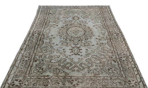 Load image 1 in gallery view. Light blue and brown distressed traditional rug with a central floral medallion and ornate border pattern.