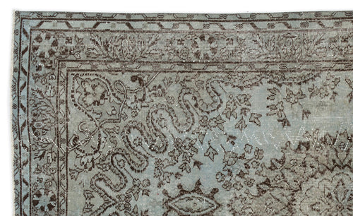 Load image 1 in gallery view. Light blue and dark brown distressed rug with a traditional floral and vine border pattern.