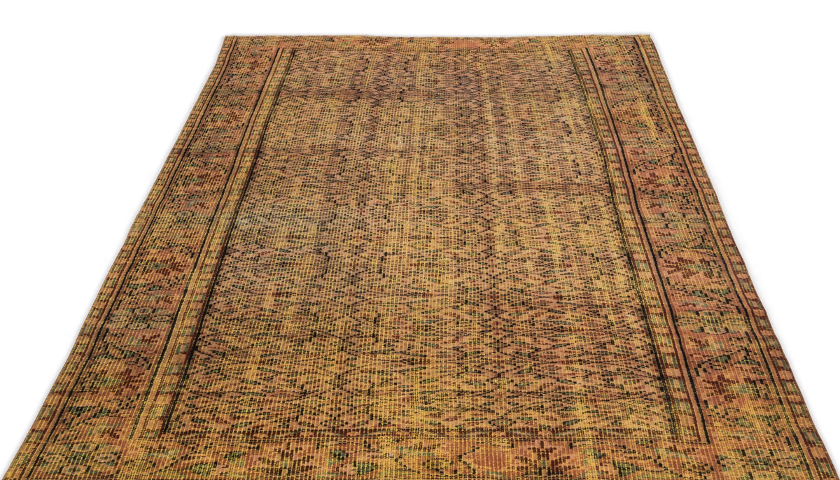 Distressed ochre and brown rug with a faded geometric pattern and dark linear borders on a white background.
