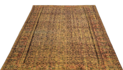 Load image 1 in gallery view. Distressed ochre and brown rug with a faded geometric pattern and dark linear borders on a white background.