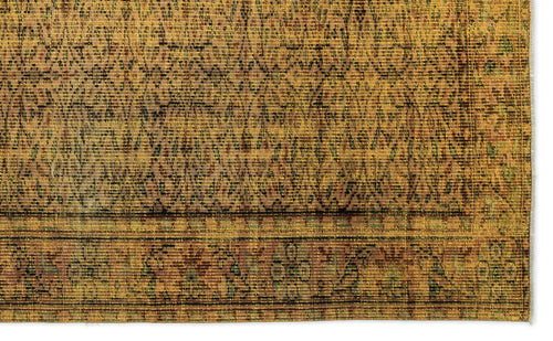 Load image 1 in gallery view. Mustard yellow and brown vintage-style rug with a distressed geometric diamond pattern and a decorative border.