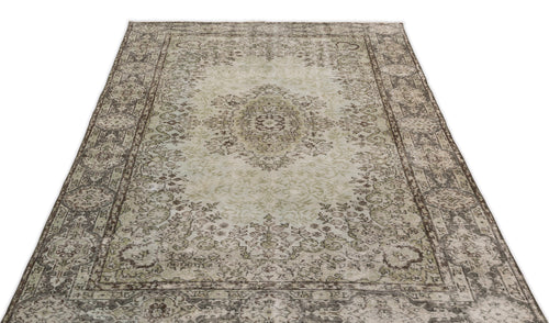 Load image 1 in gallery view. Distressed sage green and brown vintage-style rug with a central medallion and ornate floral border on a white background.