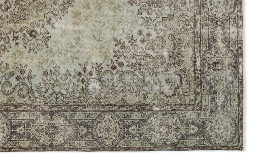Load image 1 in gallery view. Distressed sage green and brown traditional rug with an intricate floral medallion pattern and a wide decorative border.