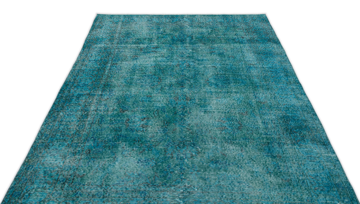 Teal and blue distressed vintage-style rug with a faded, worn-in texture on a white background.
