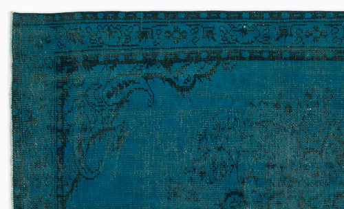 Load image 1 in gallery view. Teal and black distressed rug with a traditional ornate border and faded floral medallion pattern.
