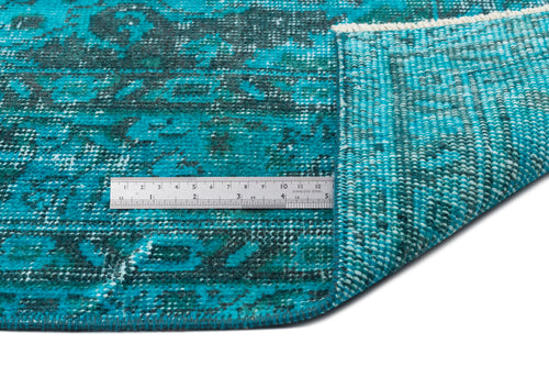 Load image 1 in gallery view. Teal and dark green distressed medallion rug with a folded corner and a stainless steel ruler for scale.