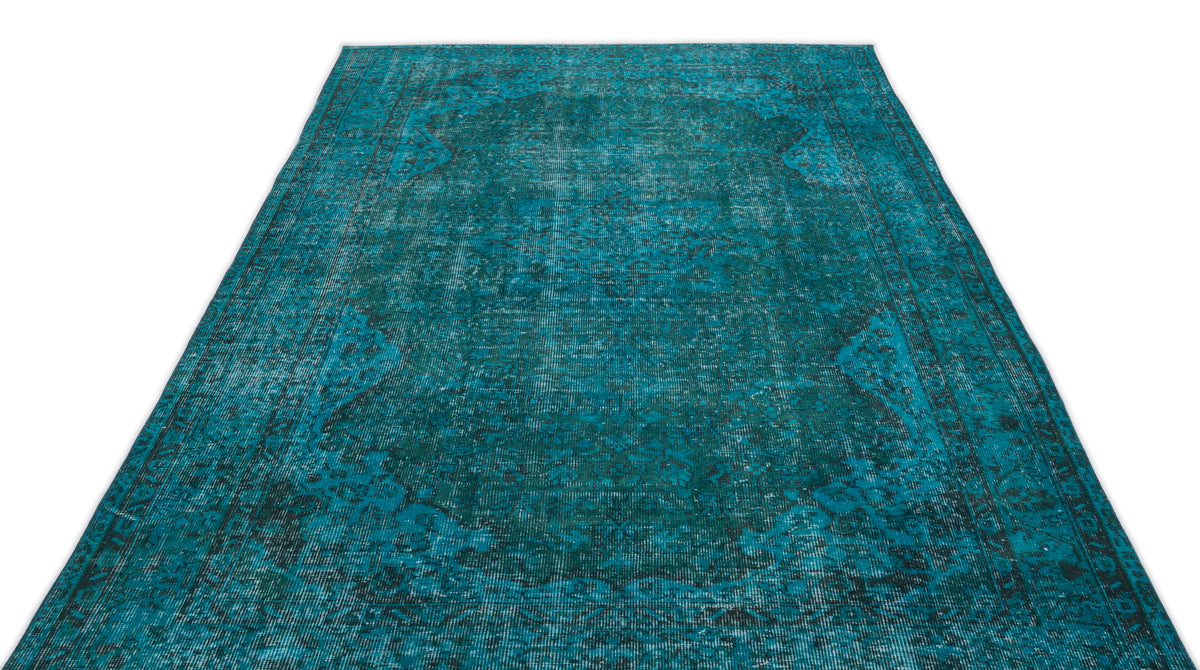 Teal and black distressed traditional rug with a central medallion pattern on a white background.