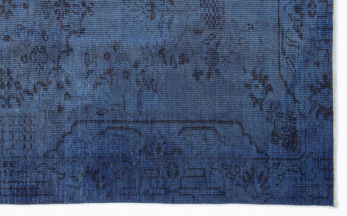 Load image 1 in gallery view. Deep blue vintage-style rug with a faded, dark charcoal traditional floral medallion pattern.