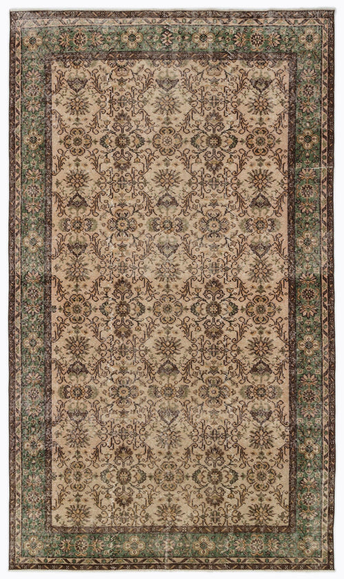 Load image 1 in gallery view. Beige, brown, and green traditional rug with a distressed floral medallion pattern and a decorative border.