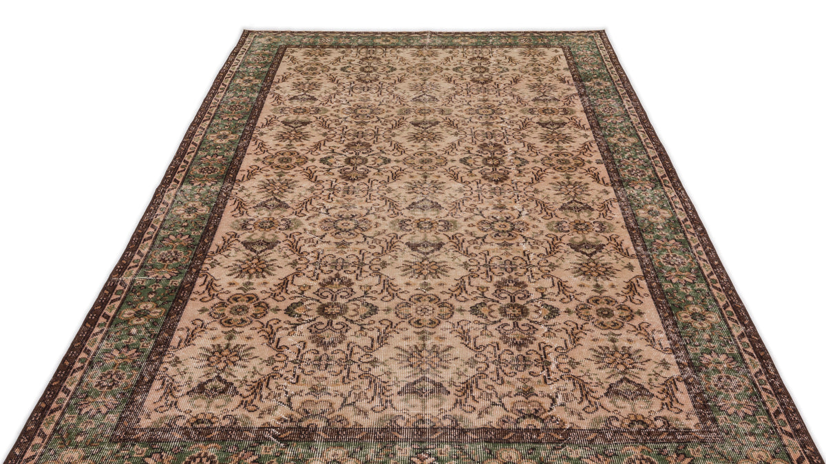 Beige and green vintage-style rug with a distressed floral medallion pattern and a dark brown border.