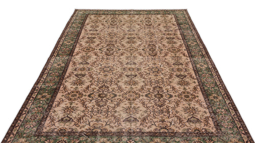 Load image 1 in gallery view. Beige and green vintage-style rug with a distressed floral medallion pattern and a dark brown border.