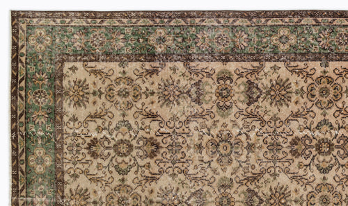 Load image 1 in gallery view. Beige, brown, and green traditional rug with a distressed floral medallion pattern and a decorative border.