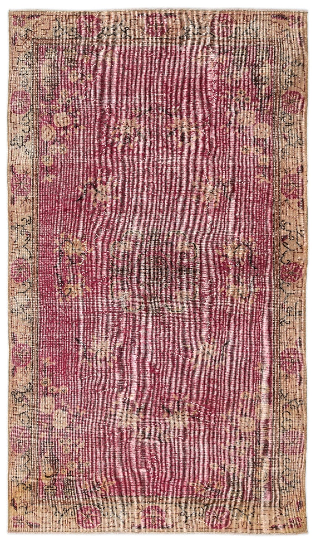 Distressed magenta rug with a central medallion, floral motifs, and a beige border on a white background.