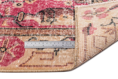 Load image 1 in gallery view. Magenta and beige vintage-style rug with a geometric pattern, showing the pile and woven backing with a metal ruler.