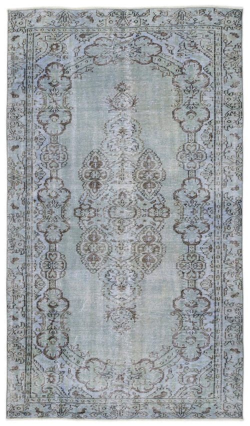 Load image 1 in gallery view. Light blue and brown distressed rug with a central floral medallion and ornate border on a white background.