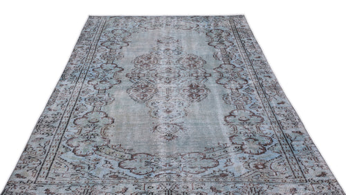 Load image 1 in gallery view. Light blue and brown distressed area rug with a traditional central medallion and ornate border pattern.