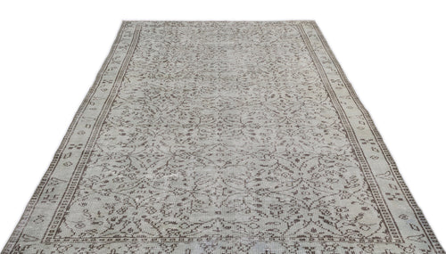 Load image 1 in gallery view. Light gray and brown vintage-style rug with a distressed floral medallion pattern and a decorative border.