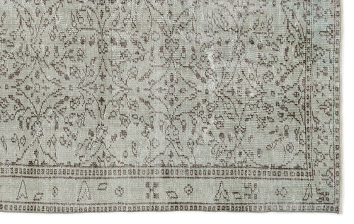 Load image 1 in gallery view. Light gray and brown distressed rug with a traditional floral medallion pattern and a geometric border.
