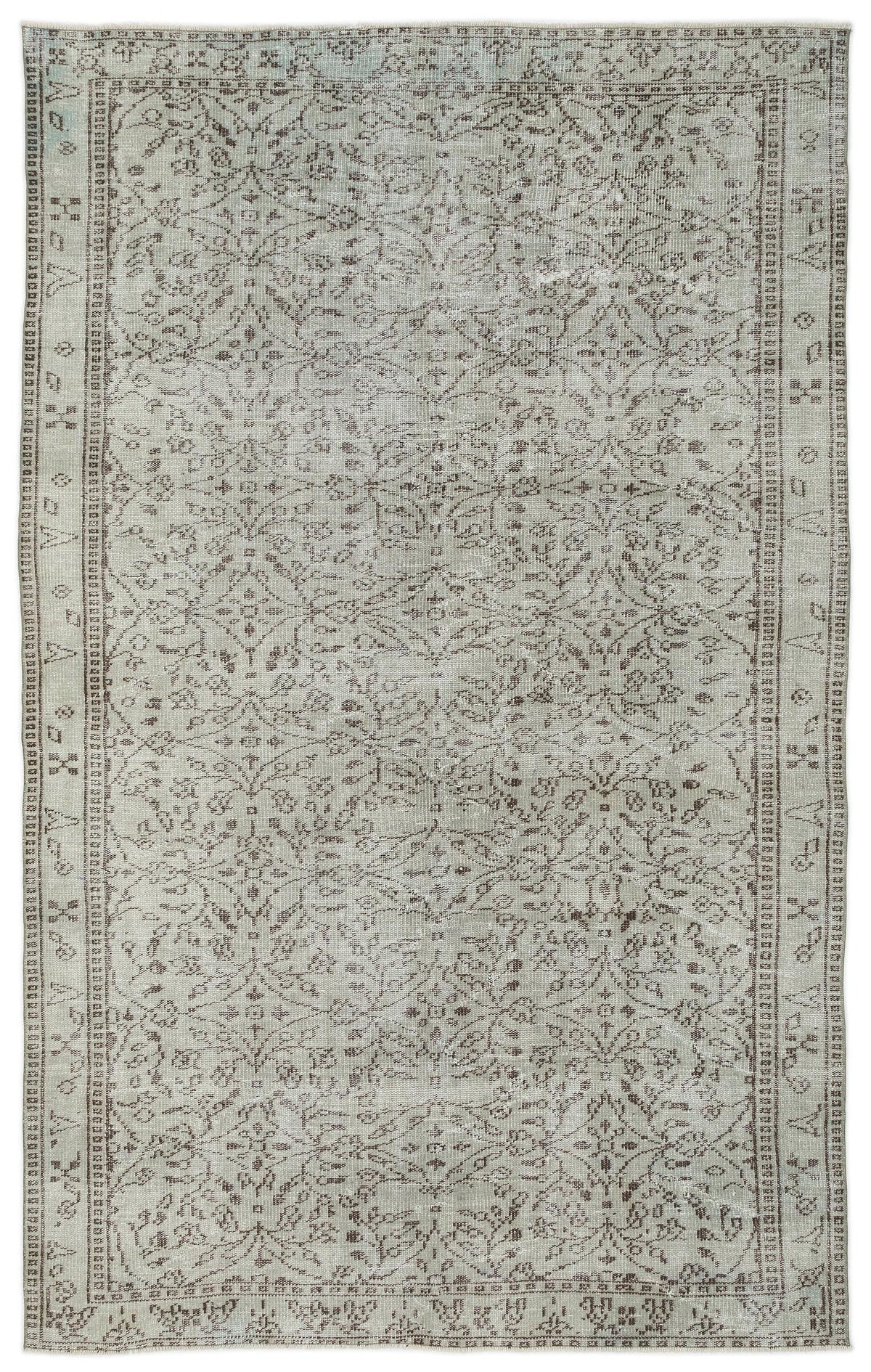 Light gray and taupe distressed rug with a traditional floral medallion pattern and a geometric border.