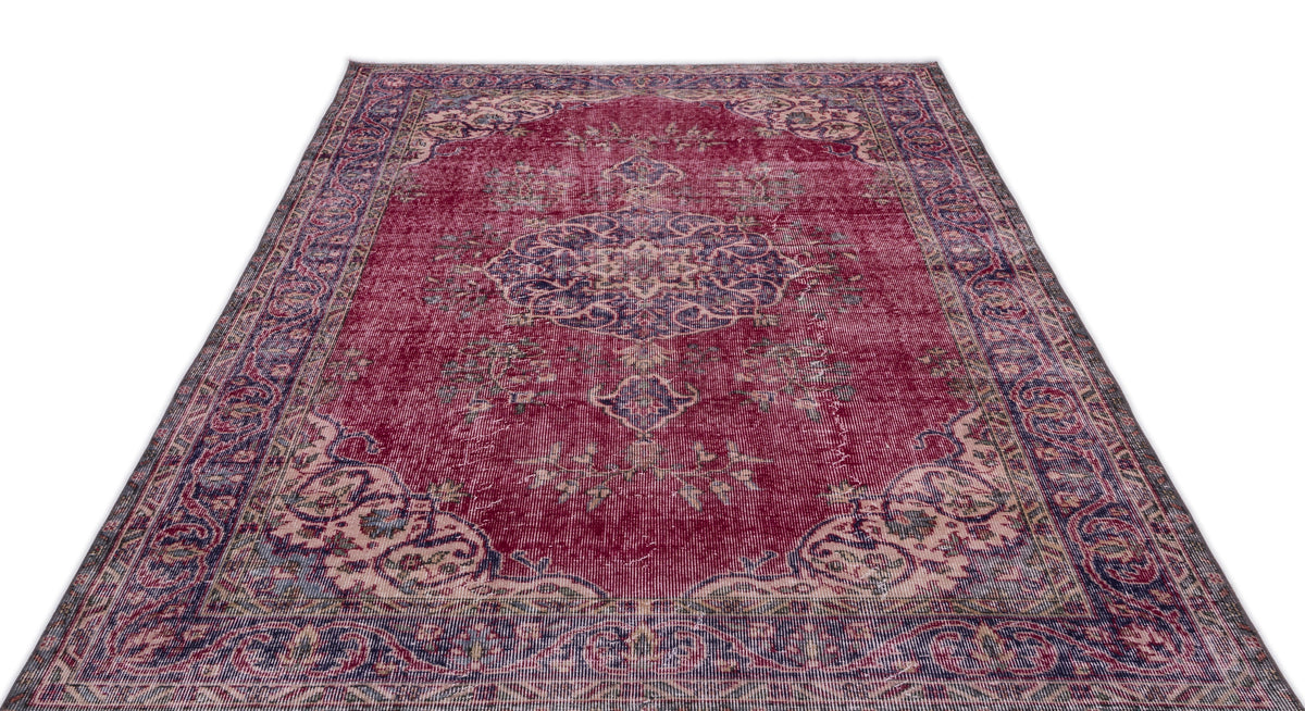 Distressed magenta and navy blue traditional Persian-style rug with a central medallion and ornate border.