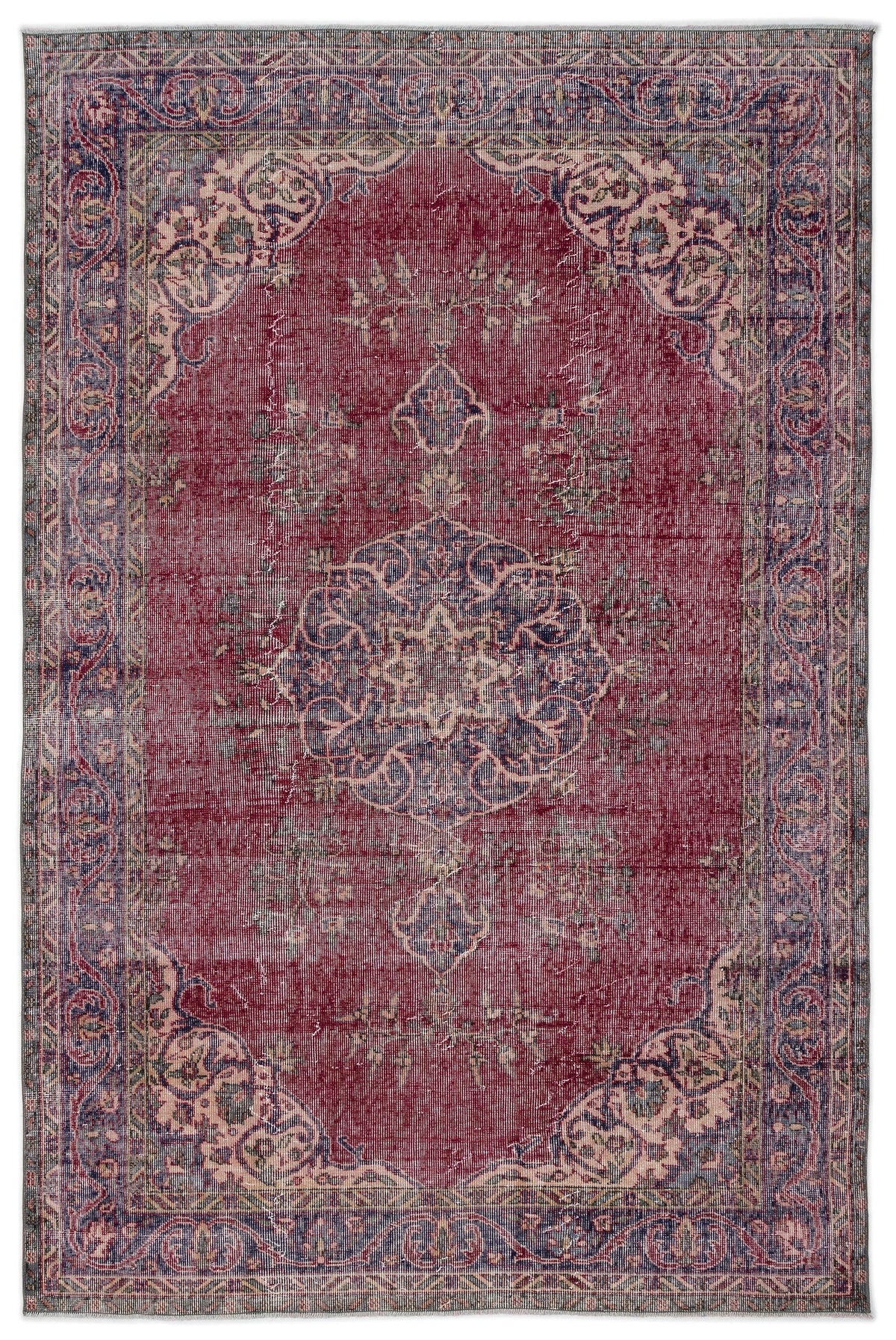 Distressed deep red traditional rug with a central blue floral medallion and ornate border on a white background.