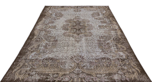Load image 1 in gallery view. Brown and light grey vintage-style rug with a central floral medallion and ornate border on a white background.