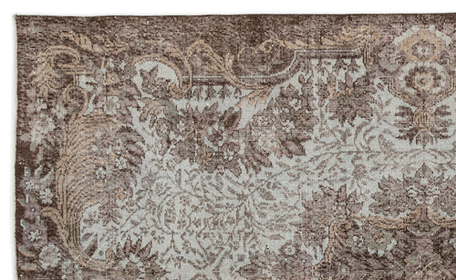 Load image 1 in gallery view. Dark brown and light blue vintage-style rug with a distressed floral medallion pattern.