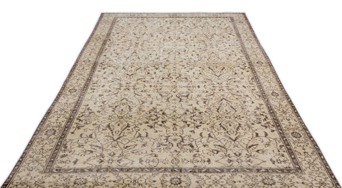 Load image 1 in gallery view. The Trabiane - Vintage Floral Rug (6'1 x 9'11) is a rectangular beige Anatolian vintage piece with intricate floral and vine motifs plus a decorative border, shown laid flat on a white background.
