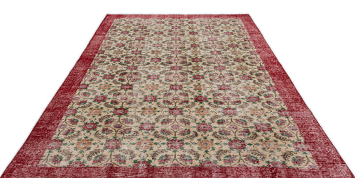Load image 1 in gallery view. Beige rug with a red border and a repeating floral medallion pattern in red, green, and blue on a white background.